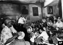 The musicians of Preservation Hall entertain jazz fans in the French Quarter of New Orleans, May 12, 1964.