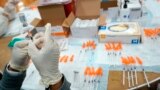 FILE - A Northwell Health registered nurse fills a syringe with a COVID-19 vaccine atthe Albanian Islamic Cultural Center in New York. The FDA on June 30 recommended that COVID-19 booster shots be modified to better match more recent coronavirus variants. 