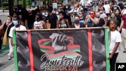 Demonstrators march through downtown Orlando, Fla., during a Juneteenth event. (File)