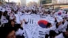 South Koreans give three cheers for the country as they march during a rally to mark the centennial of the March First Independence Movement Day against Japanese colonial rule (1910-45), in Seoul, South Korea, March 1, 2019.