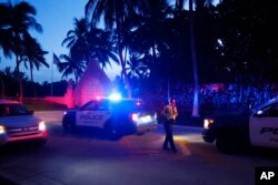 FILE - Police direct traffic outside an entrance to former President Donald Trump's Mar-a-Lago estate, in Palm Beach, Fla., Aug. 8, 2022.