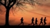 FILE - High school students run at sunset as they practice for the track and field season Monday, Feb. 28, 2022, in Shawnee, Kan. New research hints that even simple exercise just might help fend off memory problems. (AP Photo/Charlie Riedel, File)