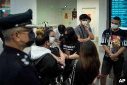 FILE - Malaysian youths rescued from human traffickers in Cambodia arrive at the Kuala Lumpur Airport Terminal in Sepang, Thursday, Oct. 6, 2022.