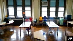 FILE - Desks are spaced apart ahead of planned in-person learning at an elementary school on March 19, 2021, in Philadelphia. Students across the United States have had “historic” drops in math and reading test scores since the start of the pandemic. (AP 