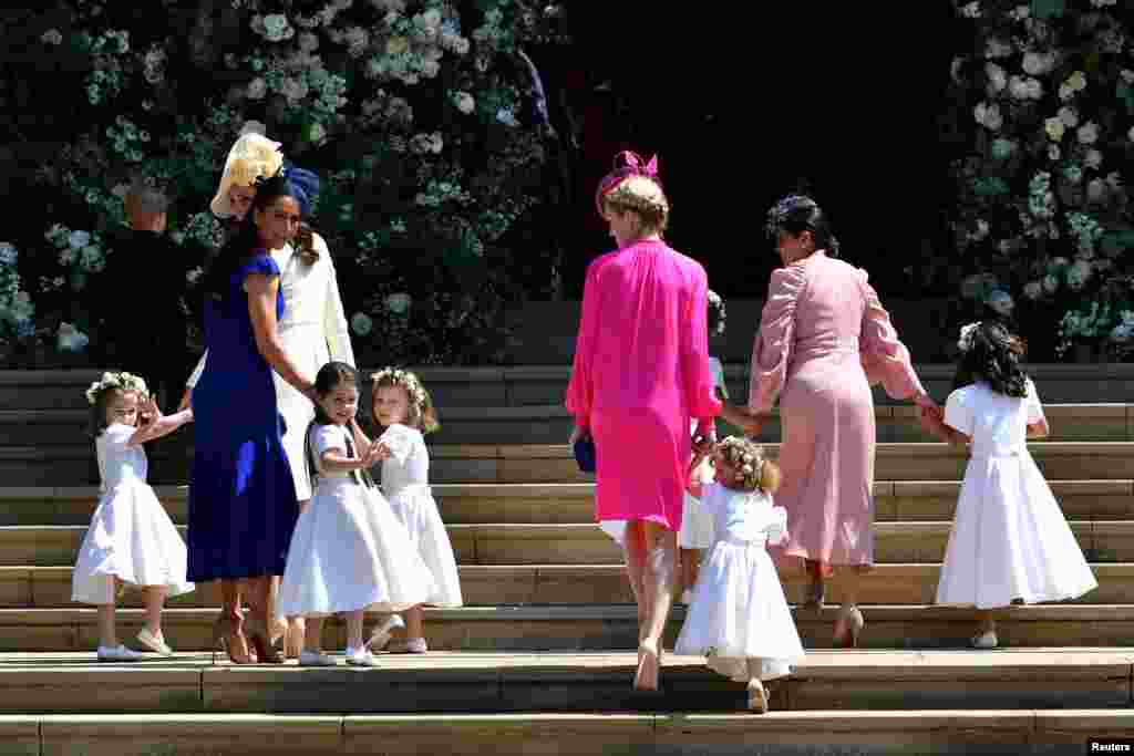 Britain&#39;s Catherine, Duchess of Cambridge and Meghan Markle&#39;s friend, Canadian fashion stylist Jessica Mulroney holds bridesmaids hands as they arrive for the wedding ceremony of Britain&#39;s Prince Harry, Duke of Sussex and U.S. actress Meghan Markle at St George&#39;s Chapel, Windsor Castle in Windsor, Britain, May 19, 2018.