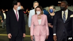 In this photo released by the Taiwan Ministry of Foreign Affairs, U.S. House Speaker Nancy Pelosi, center, arrives in Taipei, Taiwan, Tuesday, Aug. 2, 2022. Pelosi arrived in Taiwan on Tuesday night despite threats from Beijing of serious consequences. ( via AP)