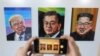 A visitor takes a photograph of images, from left, of U.S. President Donald Trump, South Korean President Moon Jae-in and North Korean leader Kim Jong Un during an exhibition at an annex of the presidential Blue House in Seoul, South Korea, Jan. 3, 2019. 
