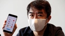 Japanese startup Donut Robotics' CEO Taisuke Ono shows the c-mask and its mobile phone application during a demonstration in Tokyo, Japan June 23, 2020. (REUTERS/Kim Kyung-Hoon)