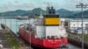 FILE - A cargo ship navigates through the Panama Canal on August 25, 2023. The number of ships allowed through the drought-hit Panama Canal each day will be increased thanks to signs of an improvement in water levels, authorities said on April 15, 2024.