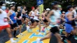 FILE - Runners cross the starting line of the 125th Boston Marathon, Monday, Oct. 11, 2021, in Hopkinton, Mass. (AP Photo/Mary Schwalm, File)