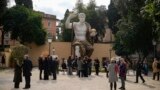 Visitors admire a massive, 13-meter replica of the statue of Roman Emperor Constantine that was built using 3D technology from scans of the nine giant original marble body parts that remain. Tuesday, Feb. 6, 2024.(AP Photo/Andrew Medichini)