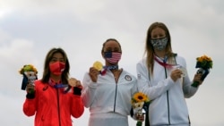 Carissa Moore, of the United States, holds the gold medal, South Africa's Bianca Buitendag holds the silver medal and Japan's Amuro Tsuzuki holds the bronze medal in the women's surfing competition at the 2020 Summer Olympics, Tuesday, July 27, 2021.