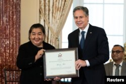U.S. Secretary of State Antony Blinken presents the 2022 Trafficking in Persons Hero Award to Apinya Tajit during the 2022 Trafficking in Persons (TIP) Report launch ceremony at the State Department, in Washington, DC, U.S., July 19, 2022.