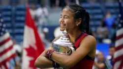 Emma Raducanu, of Britain, hugs the US Open championship trophy after defeating Leylah Fernandez, of Canada, during the women's singles final of the US Open tennis championships, Saturday, Sept. 11, 2021, in New York.
