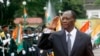 Ivory Coast's President Alassane Ouattara salutes during a parade to commemorate the country's 54th Independence Day, outside the presidential palace in Abidjan, August 7, 2014.