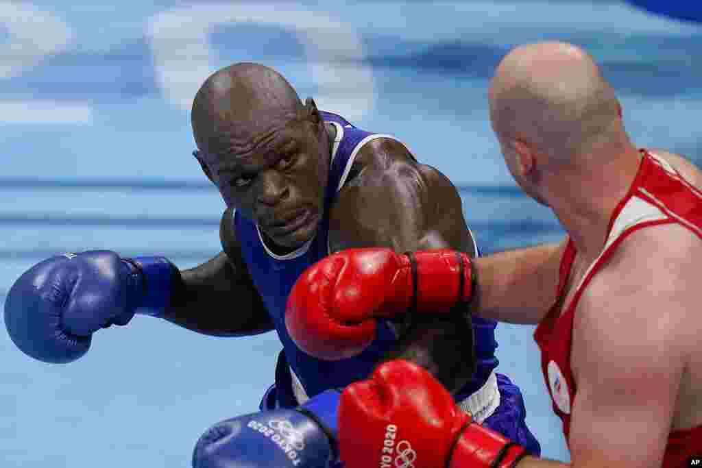 Ivan Veriasov, of the Russina Olympic Committee, right, exchanges punches with Cameroon&#39;s Maxime Yegnong Njieyo during their men&#39;s super heavyweight over 91-kg boxing match at the 2020 Summer Olympics, Thursday, July 29, 2021, in Tokyo, Japan. (AP Photo/Frank Franklin II)