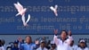 Cambodia's Prime Minister Hun Sen (R) and President of Cambodia's National Assembly Heng Samrin (L) release doves during a rally for the ruling Cambodian People's Party (CPP) ahead of the upcoming election in Phnom Penh on July 1, 2023.