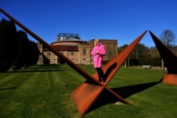 FILE Glyndebourne's Managing Director Sarah Hopwood, poses for a portrait on a sculpture "Triangles 5 (Bridge)" by Nicholas Hare, at the gardens of the famous opera house in Lewes, Britain March 9, 2021. Picture taken March 9, 2021. REUTERS/Dylan Martinez