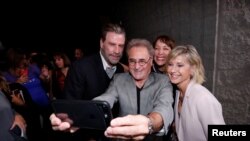 Cast members John Travolta (L), Barry Pearl, Didi Conn and Olivia Newton-John (R) pose for a selfie at a 40th anniversary screening of "Grease" at the Academy of Motion Picture Arts and Sciences in Beverly Hills, California, U.S.,