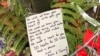 A note to the victims of Friday's mass shooting was placed alongside 50 red paper hearts near the Al Noor mosque in Christchurch, New Zealand, March 18, 2019.
