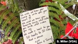 A note to the victims of Friday's mass shooting was placed alongside 50 red paper hearts near the Al Noor mosque in Christchurch, New Zealand, March 18, 2019.