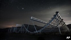  This November 2016 photo provided by the Canadian Hydrogen Intensity Mapping Experiment collaboration shows the CHIME radio telescope at the Dominion Radio Astrophysical Observatory in Kaleden, British Columbia, Canada. (Andre Renard/University of Toronto via AP)