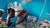 Une femme tient son nouveau-né dans une crèche d'un hôpital universitaire de Juba, le 3 avril 2013, au Soudan du Sud.