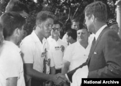When he was in high school, Clinton met President John F. Kennedy at the White House. (National Archive