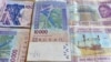 FILE - This photo taken on April 9, 2016 in a N'djamena, Chad, shows CFA banknotes of the CFA currency issued by the Central Bank of West African States, and used in the eight west African countries which share the common West African CFA franc currency.