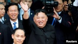 North Korean leader Kim Jong Un bids farewell to the crowd before boarding his train to depart for North Korea at Dong Dang railway station in Vietnam, March 2, 2019. 