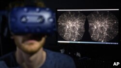 Hadrien Gurnel, software engineer at EPFL's Laboratory for Experimental Museology, explores with a virtual reality headset the most detailed 3D map of the universe with the virtual reality software VIRUP, on Tuesday, Oct. 12, 2021, in St-Sulpice near Laus