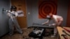 FILE - Two women use sledgehammers to destroy a TV in a rage room at Smash RX LLC in Westlake Village, Calif., Friday, Feb. 5, 2021. After a year in COVID-19 isolation, some people just want to grab a sledgehammer and smash everything in sight. (AP Photo/Jae C. Hong)
