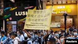 Police raise a warning banner at Causeway Bay after authorities denied permission for a protest rally during the 24th anniversary of the former British colony's return to Chinese rule, on the 100th founding anniversary of the Communist Party of China, in Hong Kong, China July 1, 2021. REUTERS/Tyrone Siu