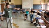FILE - ESL (English-as-a-second-language) teacher Xavier Chavez, standing, teaches a summer history class at Benson High School in Portland, Ore.,Wednesday, Aug. 6, 2008. (AP Photo/Don Ryan)