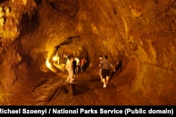 Visitors walk through the Thurston Lava Tube, or Nahuku in Hawaiian.