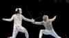Misaki Emura of Japan, left, and Amira Ben Chaabane of Tunisia compete in the women&#39;s Sabre team round of 16 competition at the 2020 Summer Olympics, Saturday, July 31, 2021, in Chiba, Japan. (AP Photo/Hassan Ammar)
