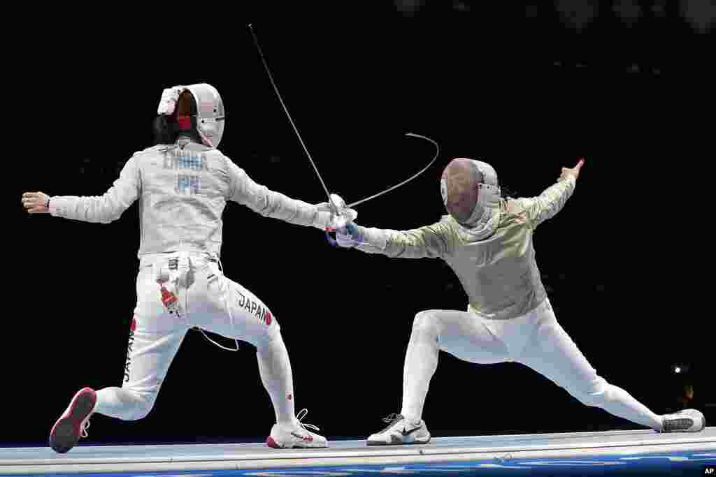 Misaki Emura of Japan, left, and Amira Ben Chaabane of Tunisia compete in the women&#39;s Sabre team round of 16 competition at the 2020 Summer Olympics, Saturday, July 31, 2021, in Chiba, Japan. (AP Photo/Hassan Ammar)