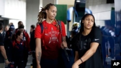 U.S. women's basketball players Brittney Griner, left, and Maya Moore board a bus at the airport after arriving at the 2016 Summer Olympics in Rio de Janeiro, Brazil, Aug. 3, 2016.