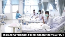 In this photo taken from a video released by the Thailand government, three of the 12 boys are seen recovering in their hospital beds after being rescued along with their coach from a flooded cave in northern Thailand. 