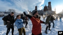 FILE - Snowballs fly during a snowball fight organized by the DC Snowball Fight Association, on the National Mall in the snow, Monday, Jan. 3, 2022, in Washington. (AP Photo/Alex Brandon)