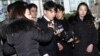 Seungri, center, member of a popular K-pop boy band Big Bang, arrives at the Seoul Metropolitan Police Agency in Seoul, South Korea, March 14, 2019.