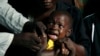 FILE - A boy reacts as he receives a yellow fever vaccine injection in the Kisenso district of Kinshasa, DRC, July 21, 2016.