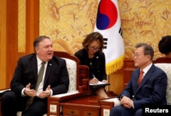 U.S. Secretary of State Mike Pompeo talks with South Korean President Moon Jae-in during their meeting at the presidential Blue House in Seoul, South Korea, Oct. 7, 2018.