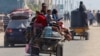 Palestinians travel in an animal-drawn cart as they flee Rafah after Israeli forces launched a ground and air operation in the eastern part of the southern Gaza Strip city on May 9, 2024.