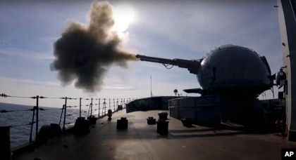 In this photo taken from video provided by the Russian Defense Ministry Press Service, a cannon mounted on a Russian warship fires during a naval exercise in the Black Sea, Feb. 18, 2022.    