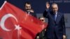 Turkey's President Erdogan and Murat Kurum greet their supporters during a rally in Istanbul