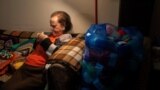 Ioanna Matsouka, 93, knits scarves in her house in Athens, Greece, March 6, 2024. (REUTERS/Karolina Tagaris)