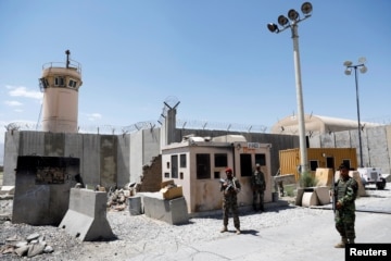Hình minh họa - Máy bay trực thăng của Hoa Kỳ rời đi, trong khi chiến binh Taliban ngồi trên chiếc xe tăng bị bỏ hoang, bao quanh bởi những bông hoa anh túc đỏ.