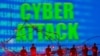LED lights and toy figures are seen in front of displayed binary code and words "Cyber Attack." (Reuters)