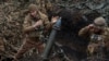 Військовослужбовці 28-ї окремої механізованої бригади стріляють із міномета у бік російських військ, поблизу міста Бахмут. 15 березня 2024 року. Фото REUTERS
